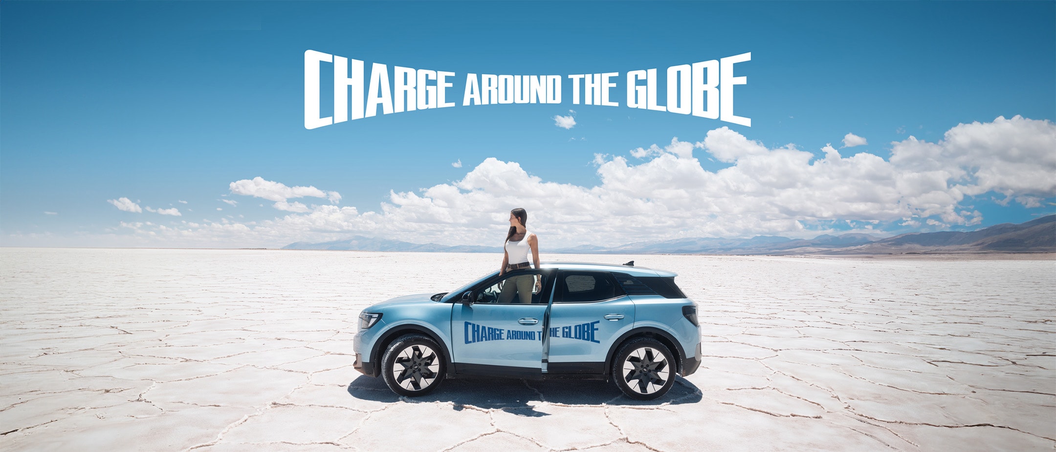 Lexie Alford, (AKA Lexie Limitless), stood with the New Ford Electric Explorer in a desert Lexie Alford, (AKA Lexie Limitless), stood with the New Ford Electric Explorer in a desert